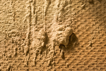 The bright wall is stained with dirty concrete.
