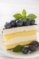 Cake of a souffle with glaze and fresh blueberries.