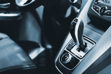 Obraz na płótnie Canvas Luxury of car interior at transmission shift gear area. Modern car interior, gearstick radio. Color tone..