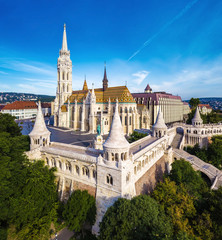 Fototapeta premium Budapest, Hungary - Aerial view of famous Fisherman's Bastion (Halaszbastya) and Matthias Church (Matyas templom) in the morning with Buda Hills at background