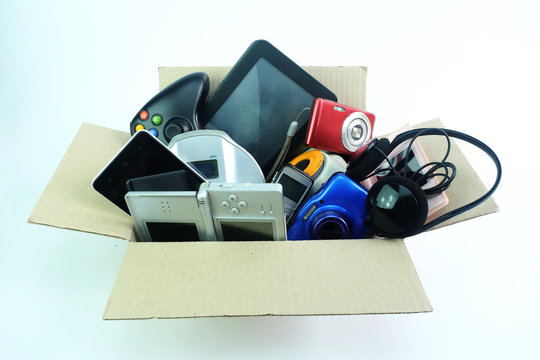 Paper box with the damaged or old used electronics gadgets for daily use on white background, Reuse and Recycle concept, Top view.