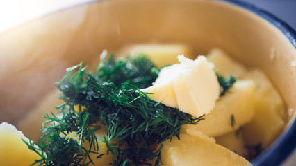 Boiled potatoes in a pan with dill.