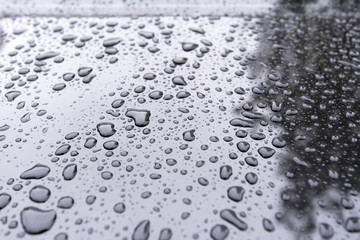 Close-up Drops on a black Car as Background
