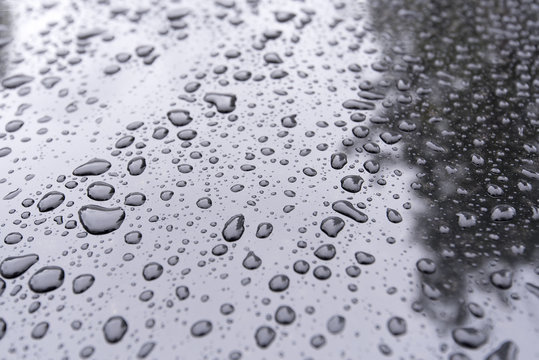 Close-up Drops on a black Car as Background