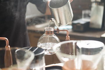 Barista with hot dip coffee