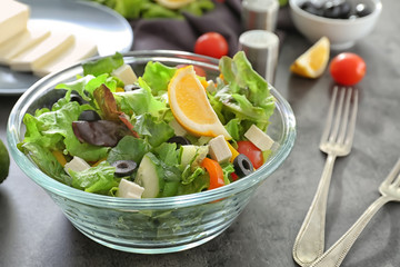 Bowl with fresh salad on table. Diet food