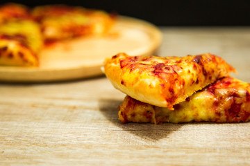 American pizza with pepperoni on a wooden table.