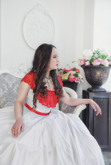 Beautiful woman in medieval dress sitting on the chair