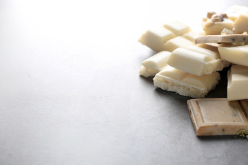 Delicious white chocolate on grey background