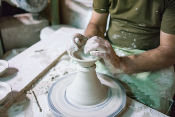 Ceramic dishes in working process. Creating ceramic pieces. Tradicional ceramic factory in spain. man working with traditional potter's wheel