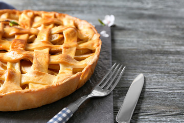 Tasty homemade apple pie on wooden table