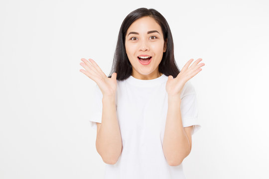 Surprised asian woman in blank white t shirt isolated. Excited and happy young korean girl. Copy space
