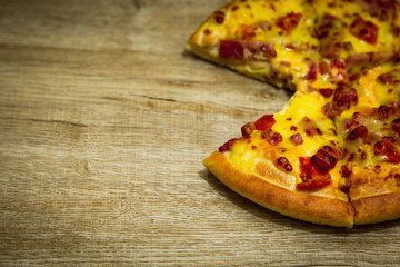 Hot pizza slice with melting cheese on a table in restaurant pizza Italian food.