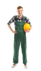 Young male electrician with hardhat on white background