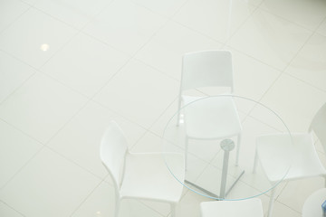 White Chair for the Customer testimonials in car showroom. Meeting room.