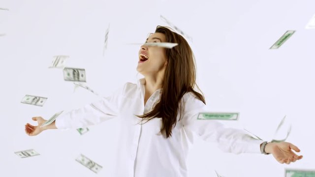 Slowmo Studio Shot Of Happy Businesswoman In Shirt Standing With Spread Arms Isolated On White Background And Laughing As Money Raining On Her From Above