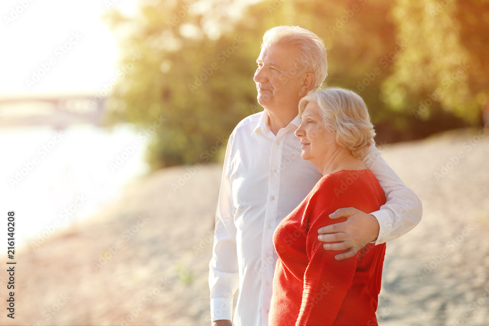 Wall mural happy mature couple on riverside