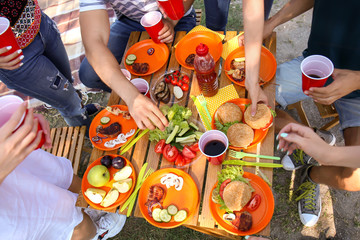 Young people having barbecue party outdoors