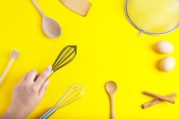 Tools pastry kitchen utensile for cooking dessert, over yellow background with copy space, still life. Top view.