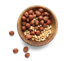 Bowl with different nuts on white background