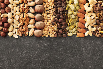 Composition with different nuts on grey background