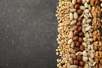 Composition with different nuts on grey background
