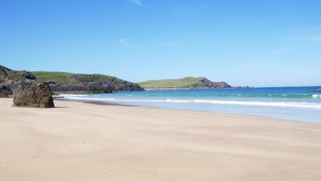 Deserted and rocky and clean beach near cliffs at Sango Sands, Durness, Scotland.