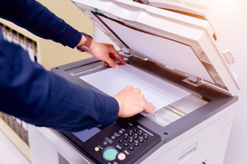 Bussiness man Hand press button on panel of printer, printer scanner laser office copy machine...