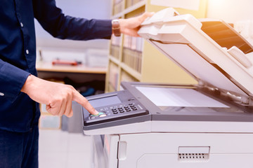 Bussiness man Hand press button on panel of printer, printer scanner laser office copy machine...