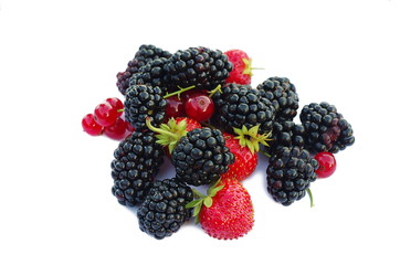 Fresh berries fruits with strawberries, blackberries, red currants on white background. Summer berries mix