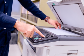Bussiness man Hand press button on panel of printer, printer scanner laser office copy machine...