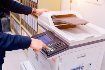 Bussiness man Hand press button on panel of printer, printer scanner laser office copy machine...