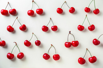Obraz na płótnie Canvas Flat lay composition with ripe cherries on light background