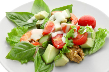 Plate with tasty avocado salad on white background, closeup