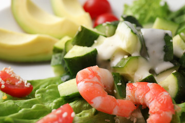 Tasty salad with ripe avocado on plate, closeup