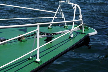 Bow of a green warship against the blue sea with  anchor at the bow. copy space, selective focus, narrow depth of field