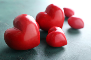 Red hearts on green background, closeup