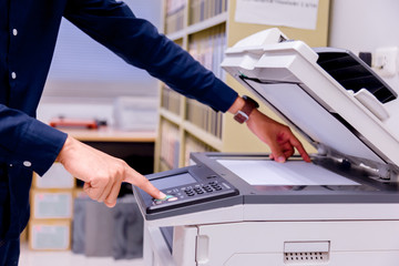 Bussiness man Hand press button on panel of printer, printer scanner laser office copy machine...