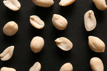Tasty peanuts on dark background