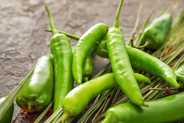 Fresh chili peppers on grey textured background, closeup