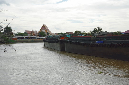 big container sand boat sailing on canal in Thailand