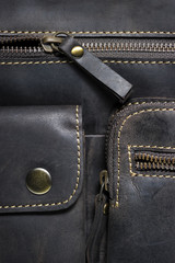 Leather bag with zipper, magnetic clasp on pocket and stitches, man accessories in vintage style, macro shot, selective focus 