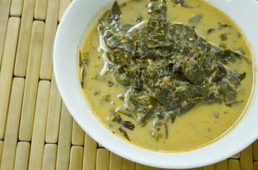 boiled Cassia tree leaf or Thai copper pod with coconut milk and curry on bowl