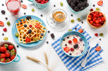 Photo of Viennese waffles, oatmeal, coffee, raspberries, strawberries, gooseberries