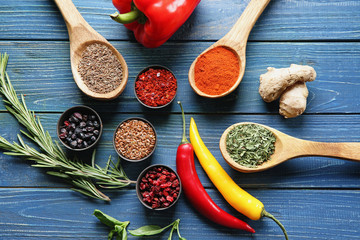 Composition with different spices on wooden background