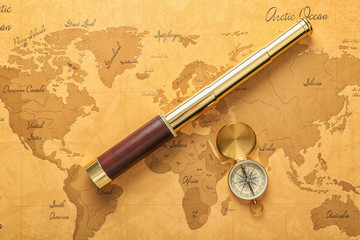 Vintage compass with spyglass on world map