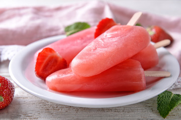 Plate with tasty strawberry ice-cream on table