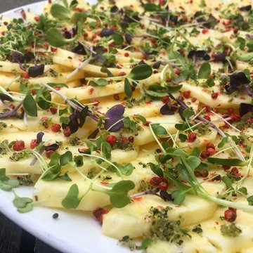 Close-up of a Pineapple salad with pink peppercorns and cress