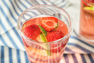 Tasty natural lemonade with strawberries in glass, closeup