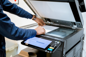 Bussiness man Hand press button on panel of printer, printer scanner laser office copy machine...
